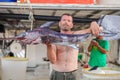 Bali, Island Crete, Greece, - June 30, 2016: Man is a fisherman carries a big fish sawfish