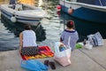 Bali, Island Crete, Greece, - June 30, 2016: Two greek women are catching fish from the pier located on Crete island in Greece.