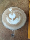 Bali Island, 06 October 2022 : Coffee latte art on wooden table in coffee shop, Indonesia Royalty Free Stock Photo