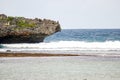 Bali ocean wave sea beach with stone rock cliff and sky background landscape in Indonesia Royalty Free Stock Photo