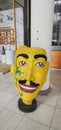 The display of art in front of the hotel is in the form of a large face painted in yellow.