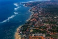 Bali's coastline with densely packed houses and hotels photographed from a plane.