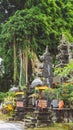 Bali temple entrance with guardian statue and Huge ancient Banyan tree in background. Indonesia Royalty Free Stock Photo