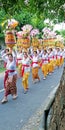 Bali temple festival procession on the street with many colorful of big offerings Royalty Free Stock Photo