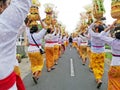 Bali temple festival procession on the street with many colorful of big offerings Royalty Free Stock Photo