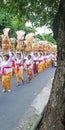 Bali temple festival procession on the street with many colorful of big offerings Royalty Free Stock Photo