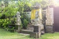 Bali Temple with Three Statues On Lush Green Garden Royalty Free Stock Photo