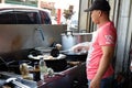 BALIKPAPAN/INDONESIA - FEBRUARY 6, 2016: A man frying roti mantau mantau bread, a traditional Indonesian snack bread that looks