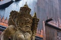 Balinese Carved Stone Statue of Rakasa covered with green moss.Thailand