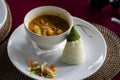 Balinese chicken dish served with traditional cone shaped leave wrapped rice and vegetables