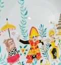 Balinese dancers and traditional ornaments are beautifully painted on the plate
