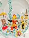 Balinese dancers and traditional ornaments beautifully painted on a plate