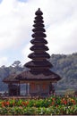 Balinese Ethnic Multi-tiered Meru Temple Buildings Surrounded By Flower Gardens On The Shores Of Lake Beratan