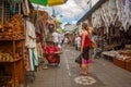 A balinese and an european woman at the marketplace