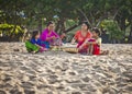 Balinese family prayed in front of Kuta Beach, Bali, Indonesia.