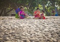 Balinese family prayed in front of Kuta Beach, Bali, Indonesia.