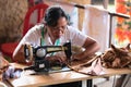 Balinese female tailor sew on a machine