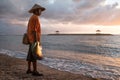 Balinese fisherman fishing on a beach at sunrise.