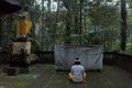 balinese guy praying at small temple in the jungle of tampaksiring gianyar bali indonesia