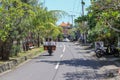 Balinese man with huge luggage on scooter on the raod to echo be