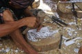 A Balinese man is making carvings