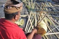 Balinese man preparing Traditional Bali Penjor bamboo pole in Bali Indonesia