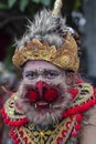 Balinese man, wearing a Hanuman mask, participates in a street ceremony in island Bali, Indonesia