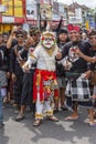 Balinese man, wearing a Hanuman mask, participates in a street ceremony in island Bali, Indonesia