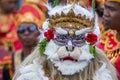 Balinese man, wearing a Hanuman mask, participates in a street ceremony in island Bali, Indonesia