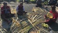 Balinese men preparing Traditional Bali Penjor bamboo pole with decoration