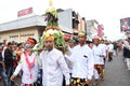 Balinese men in traditional dress bringing offerings to Hindu temple,