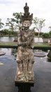 Balinese mythology protector and warrior statue. on Bali.Stone statue in tropical garden on Bali island.