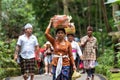 Balinese parade with woman carrying offering for Hindu God in Ubud Monkey Forest Temple