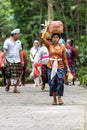 Balinese parade with woman carrying offering for Hindu God in Ubud Monkey Forest Temple