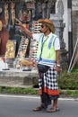 Balinese parking attendant on the main street of Ubud