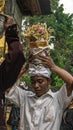 Balinese people carry offerings on their heads after a procession. Royalty Free Stock Photo