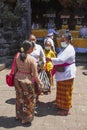 Balinese people dressed in traditional clothing at a temple Ceremony in Bali.