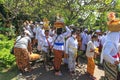 Balinese people dressed in traditional clothing at a temple Ceremony in Bali.