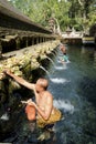 Balinese people praying at holy spring water at Pura Tirtha Empul