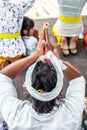 Balinese people praying on a traditional ceremony. Bali island.