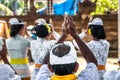 Balinese people praying on a traditional ceremony. Bali island.