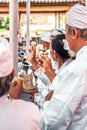 Balinese people praying on a traditional ceremony. Bali island.