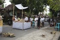 Balinese people preparing for the ceremony of cremation, bringing offerings outside in the street, Bali Island, Indonesia