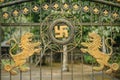 Balinese temple gate with Swastica and two lions. Royalty Free Stock Photo