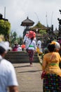 Balinese woman carries offerings to the temple. Back view