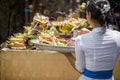 Balinese woman carrying offering to local temple in Bali,