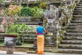 Balinese woman leaving offerings at Pura Kehen, Balinese Hindu temple in Bangli Regency, Bali, Indonesia