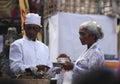 A Balinese woman and a local priest in traditional clothes on Hindu Temple ceremony, Bali Island, Indonesia