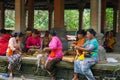 Balinese woman preparing for doing daily hindu offering is a tradition, Monkey forest, Bali, Indonesia, 10.08.2018 Royalty Free Stock Photo