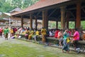 Balinese woman preparing for doing daily hindu offering is a tradition, Monkey forest, Bali, Indonesia, 10.08.2018 Royalty Free Stock Photo